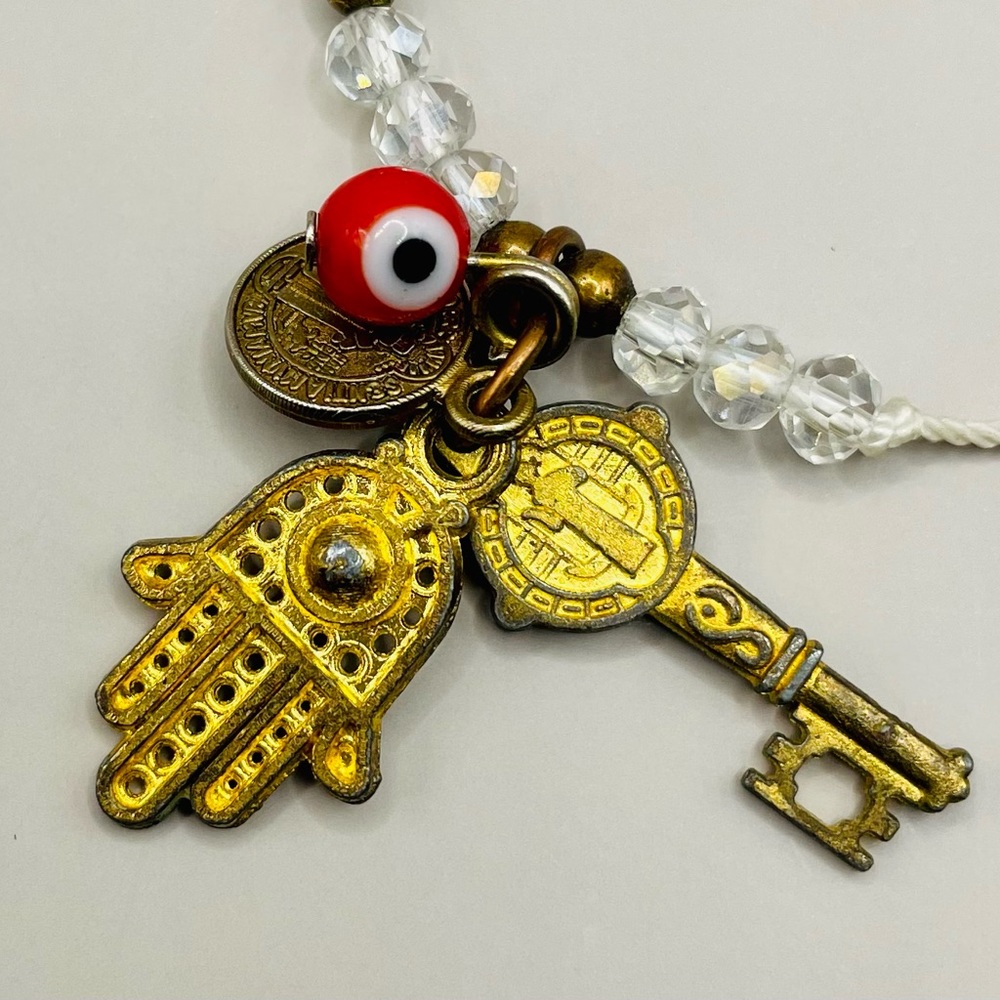 Good luck evil eye adjustable cord bracelet with multi beads and charms.